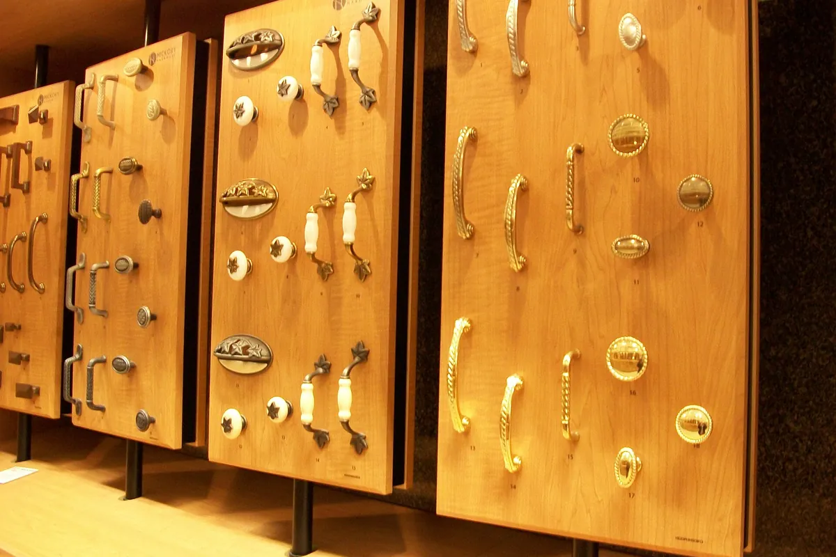 Cabinet knobs and pulls displayed on wooden sample boards for a Lancaster CA cabinet project