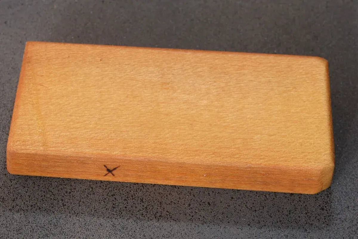 Wood sample with an oil finish showing grain and colour, used for comparing cabinet finishes