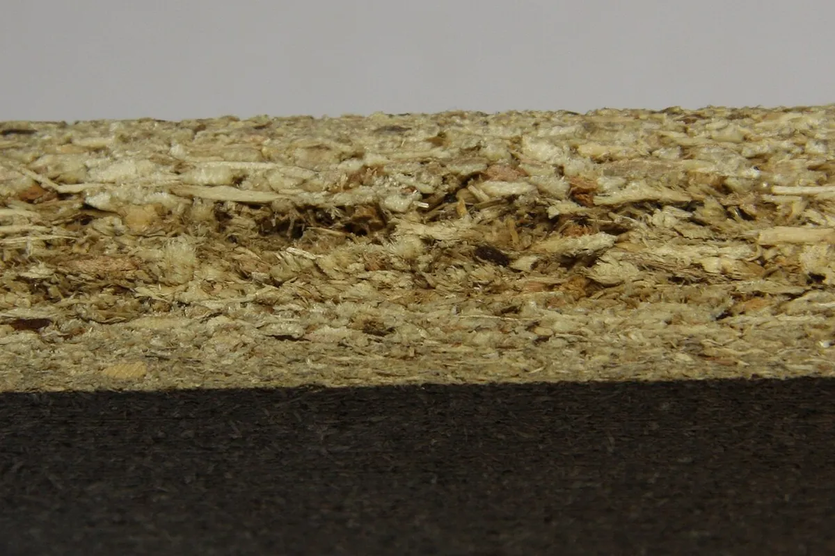 Close up of a particleboard cut edge, the common carcase material in Lancaster CA tract kitchen cabinets