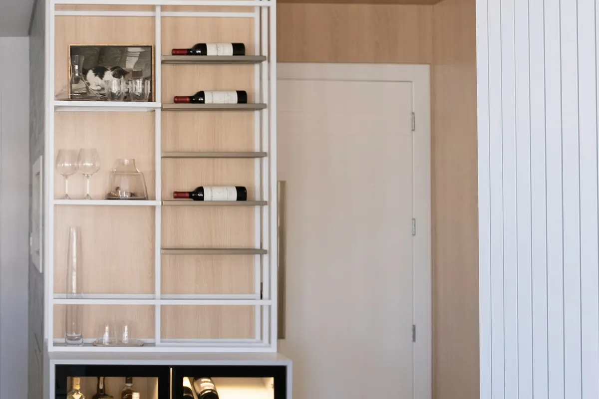 Custom wine cabinet with bottle racking, glass shelving and an undercounter beverage unit